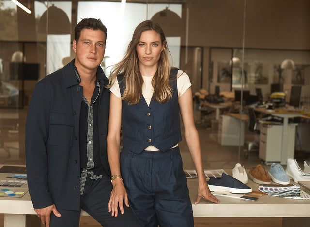 Hope and Justin Schneider standing in front a table with shoes