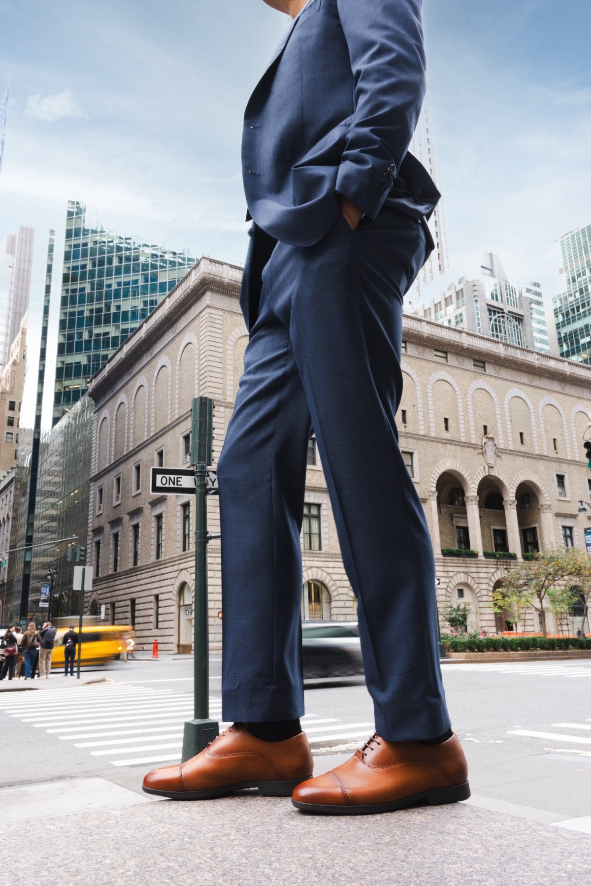 Low-angle view of whiskey full grain calfskin Capital Leather Oxfords on a Manhattan corner