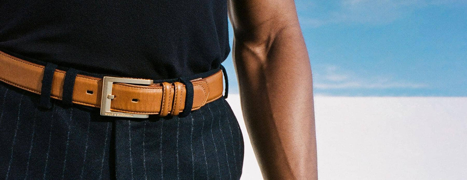 Man wearing a honey colored leather belt in the desert.