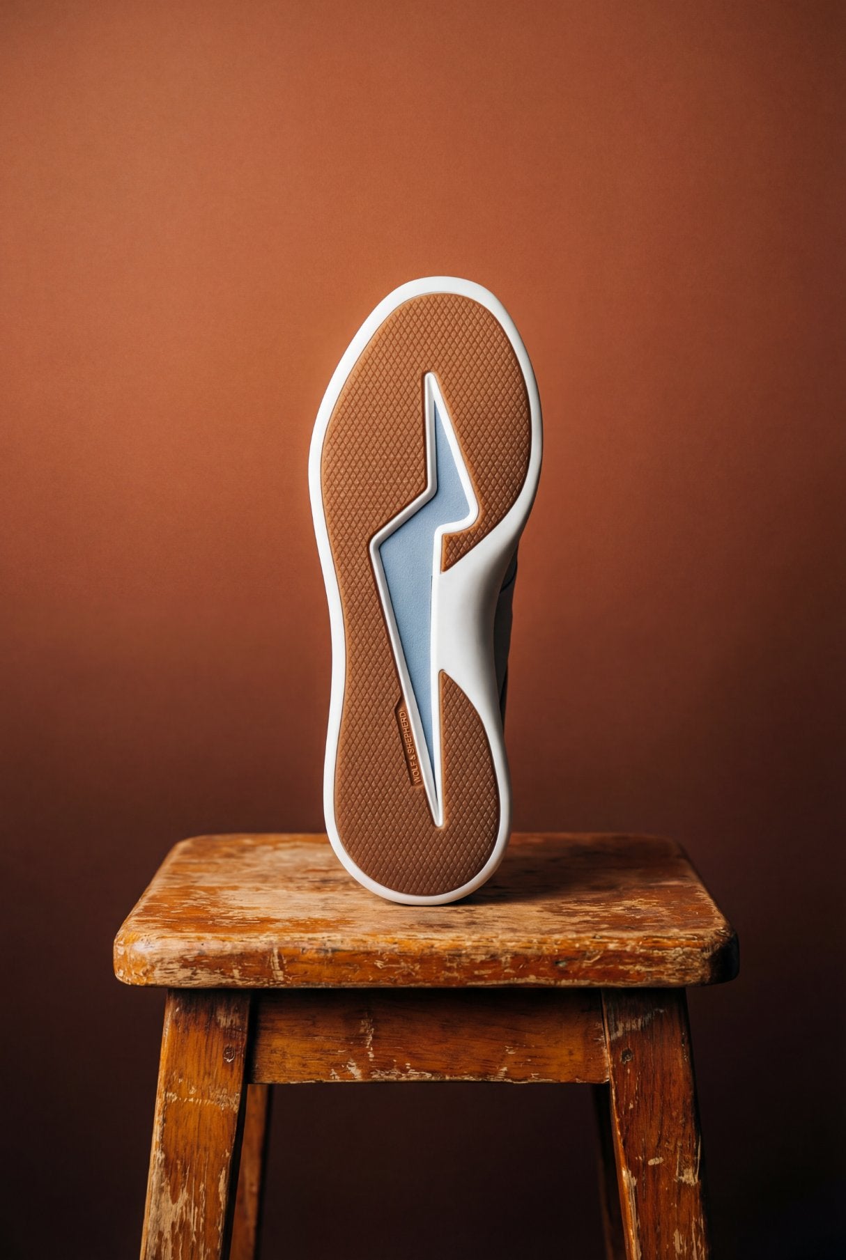 Generated with Kive.ai - sitting on a beautiful slightly rustic wooden stool   no model  keep the wordmark Wolf shepherd identical to the reference 1.jpg